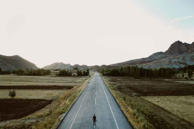 person standing on road